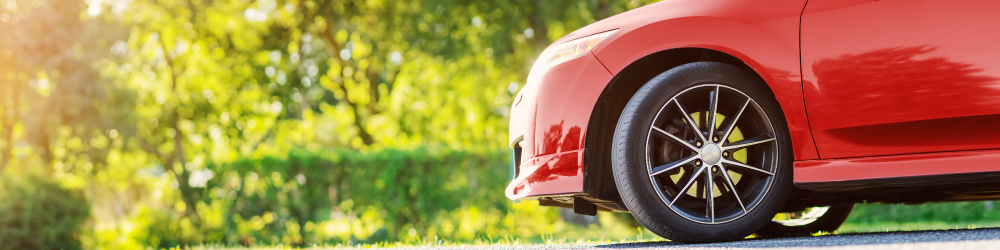 front side panel of red car in outdoor setting