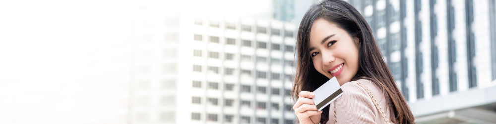 woman smiling with credit card