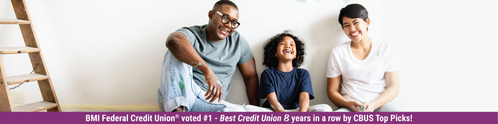 Family sitting down smiling 