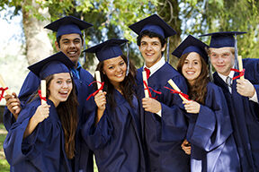 graduates holding up their diplomas 