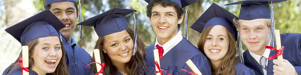Graduates smiling with their diploma