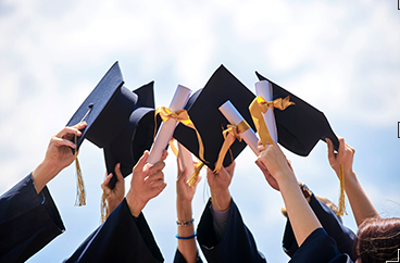 caps and gowns and hands up