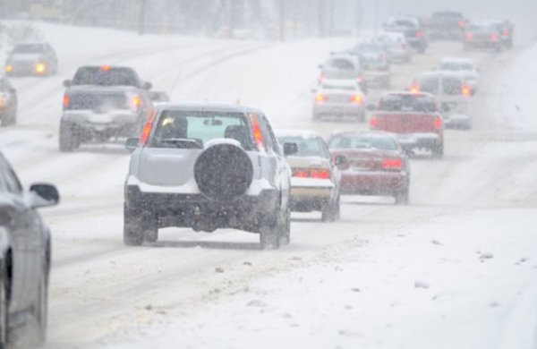 cars driving in snow storm