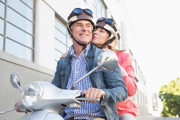 couple smiling on moped