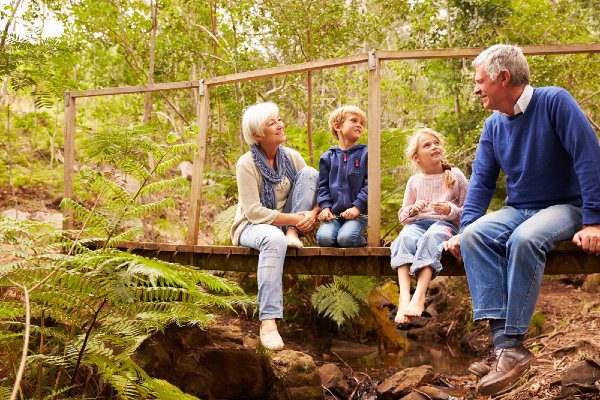 elder couple with grandkids in a forest