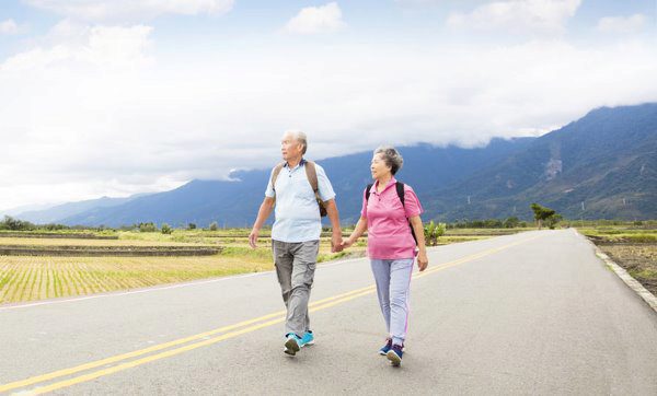 elderly people smiling on a hike