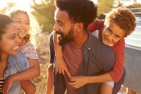 family of four laughing