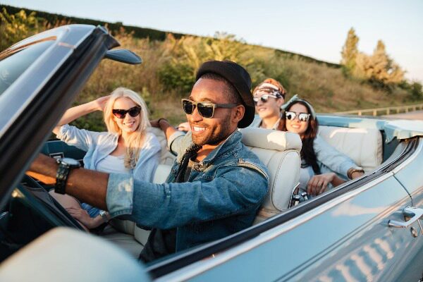 friends driving in a convertible