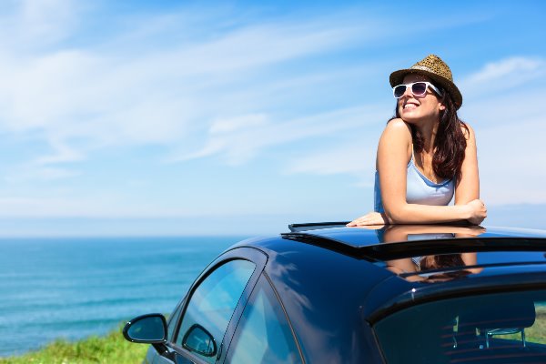 girl in parked car with sunroof open