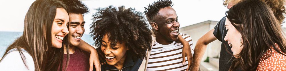 Group of young friends laughing and smiling.