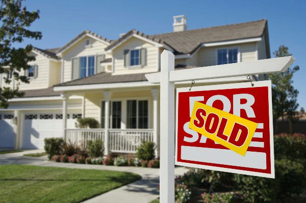 home with sold sign on lawn