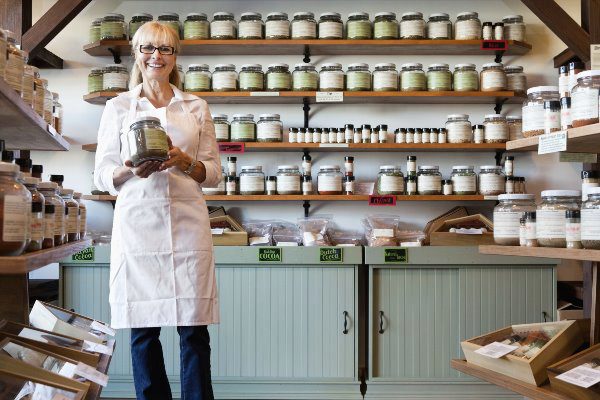 lady holding a jar in a shop of jars