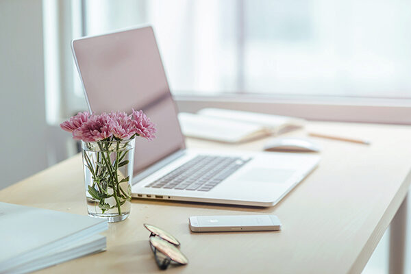laptop in the sun with flowers