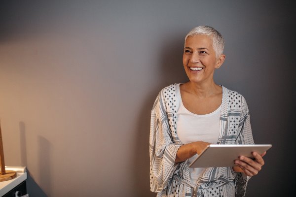 older lady with tablet smiling
