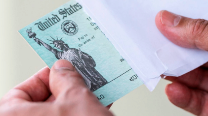 person holding stimulus check
