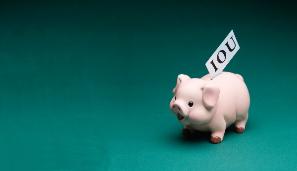piggy bank with IOU ribbon