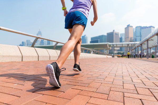 person jogging down city path