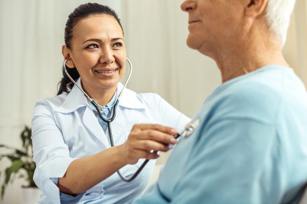 doctor checking patients heart